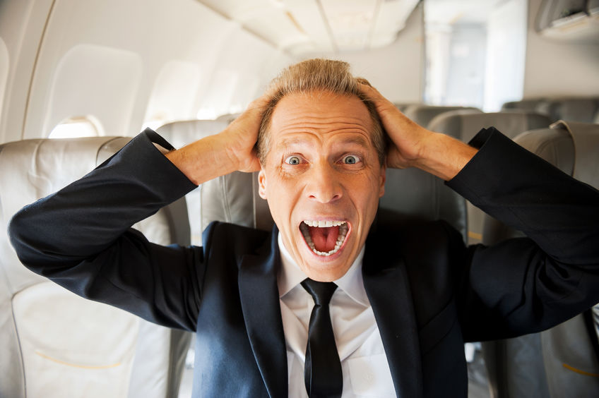 how to stop a panic attack - man panicking on plane