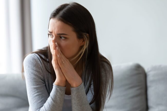 overwhelmed woman crying at home