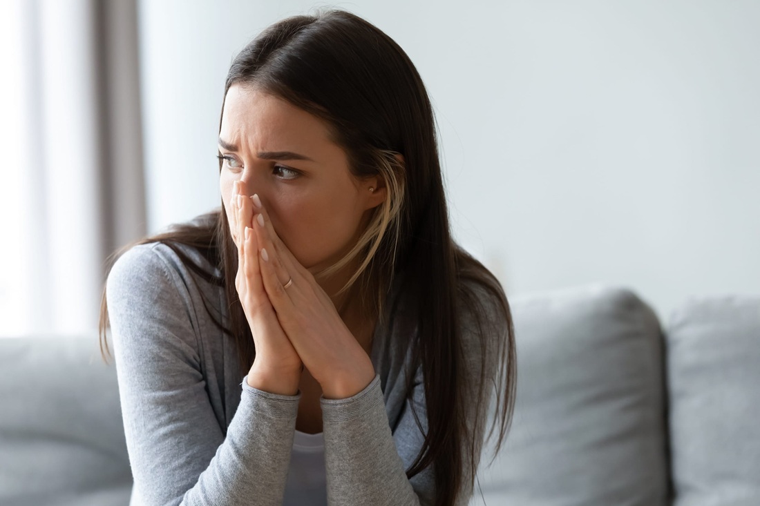 overwhelmed woman crying at home