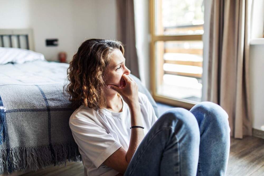Woman with health OCD ruminating in her room